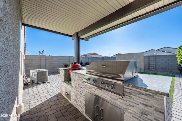 view of patio / terrace with an outdoor kitchen, cooling unit, and area for grilling