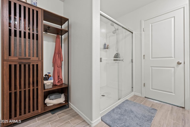 bathroom featuring a shower with shower door