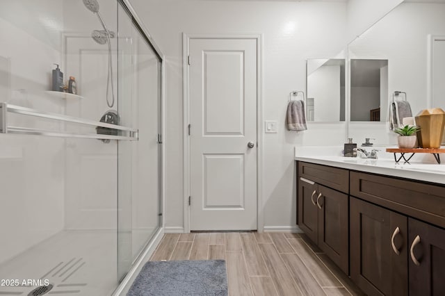 bathroom featuring vanity and an enclosed shower