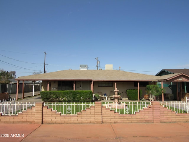 ranch-style house featuring roof with shingles and fence