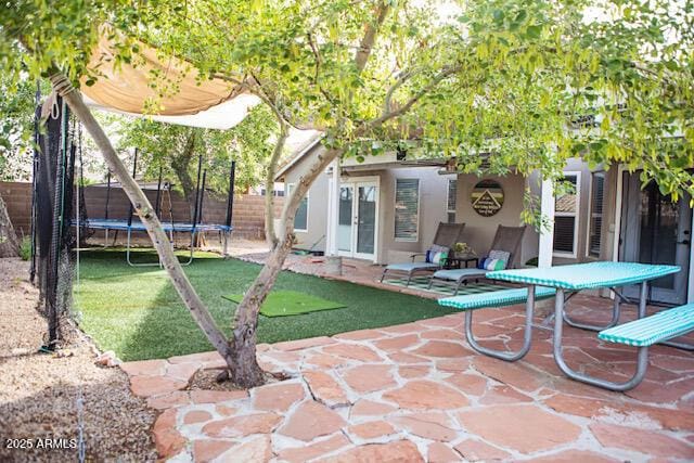 3446 N Ravine, Mesa, AZ 85215 - view of patio / terrace with a trampoline and french doors