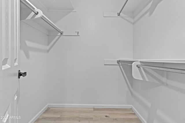 9917 W Cameo Dr, Sun City, AZ 85351 - walk in closet with light wood finished floors