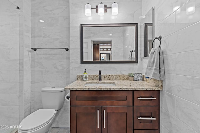 9917 W Cameo Dr, Sun City, AZ 85351 - bathroom with tile walls, vanity, and toilet