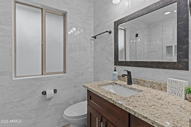 9917 W Cameo Dr, Sun City, AZ 85351 - bathroom featuring toilet, tile walls, vanity, and tiled shower