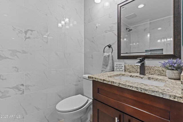 9917 W Cameo Dr, Sun City, AZ 85351 - full bathroom featuring tile walls, toilet, a tile shower, and vanity