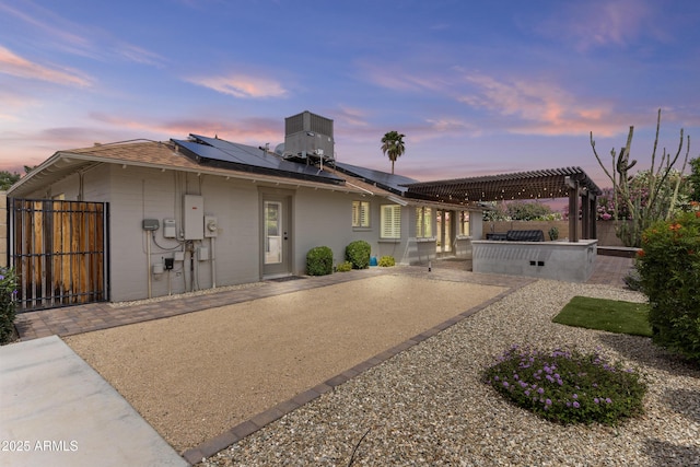 9917 W Cameo Dr, Sun City, AZ 85351 - view of front of property with a patio, roof mounted solar panels, central air condition unit, a pergola, and a fenced backyard