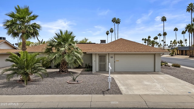 9917 W Cameo Dr, Sun City, AZ 85351 - single story home with an attached garage, concrete driveway, brick siding, and roof with shingles