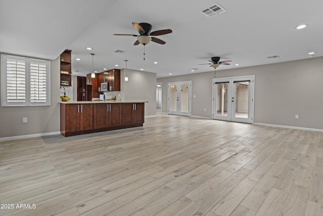 9917 W Cameo Dr, Sun City, AZ 85351 - unfurnished living room featuring ceiling fan, baseboards, recessed lighting, light wood-type flooring, and french doors