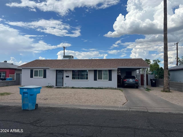 single story home featuring a carport