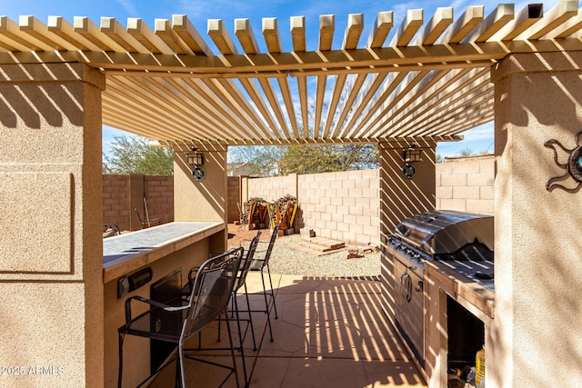 view of patio / terrace featuring outdoor dry bar, fence, a grill, and a pergola