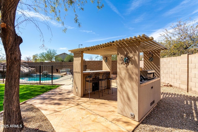 view of patio / terrace with outdoor dry bar, fence private yard, and a fenced in pool