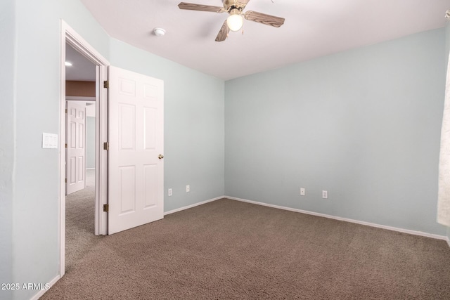 unfurnished bedroom featuring ceiling fan, dark carpet, and baseboards