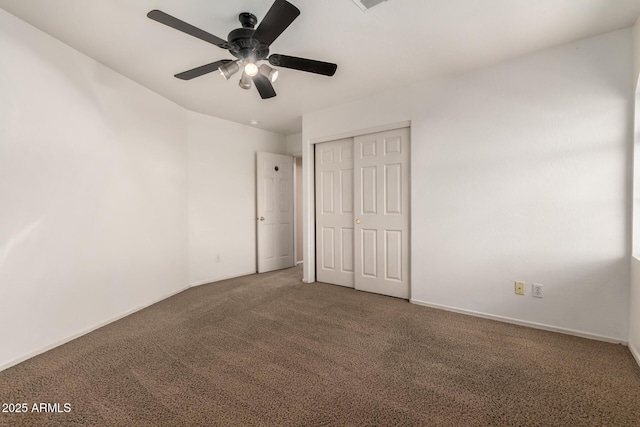 unfurnished bedroom with carpet, a closet, visible vents, a ceiling fan, and baseboards