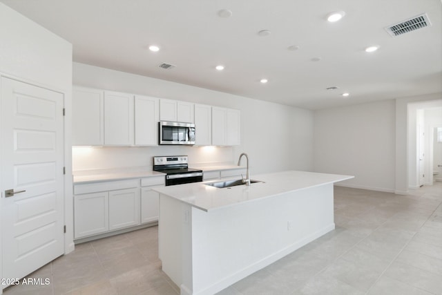 kitchen featuring white cabinetry, an island with sink, and appliances with stainless steel finishes