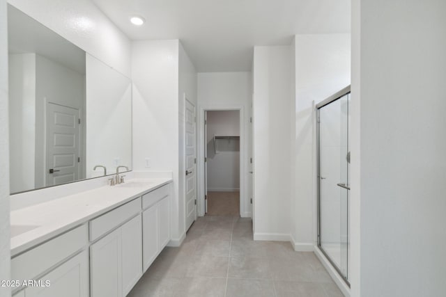 bathroom with vanity, tile patterned flooring, and a shower with door