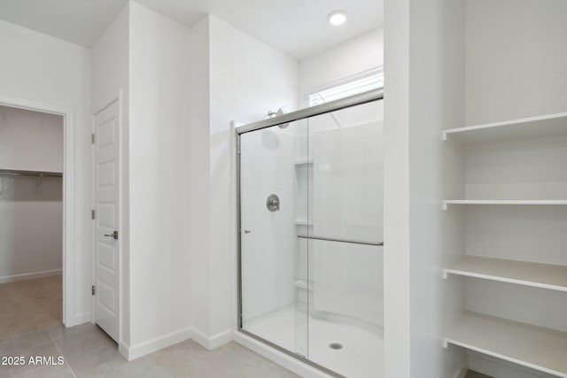 bathroom featuring tile patterned flooring and a shower with door