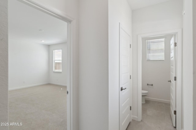 corridor featuring light tile patterned flooring