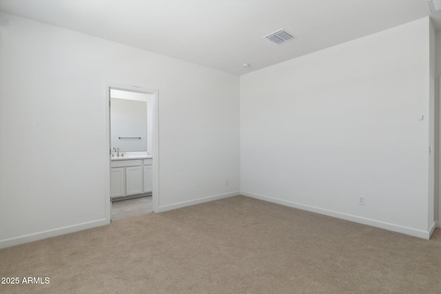 carpeted spare room with sink