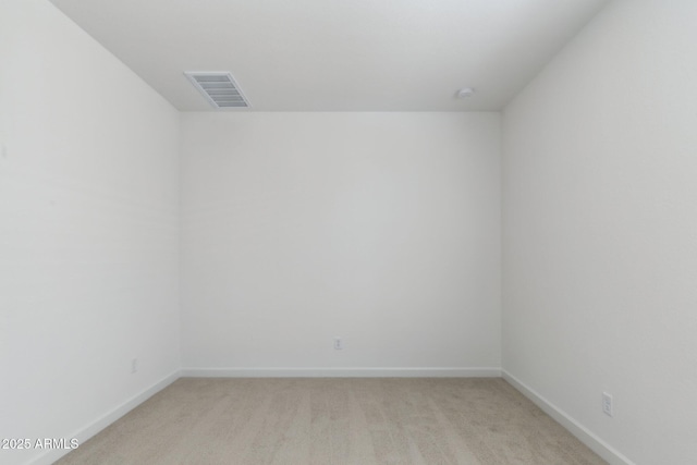 unfurnished room featuring light carpet