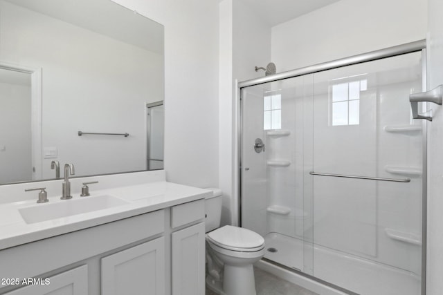 bathroom featuring walk in shower, vanity, and toilet