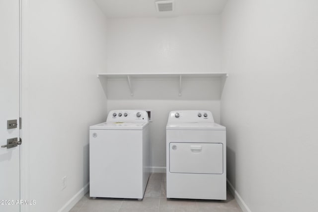 laundry area featuring light tile patterned flooring and independent washer and dryer