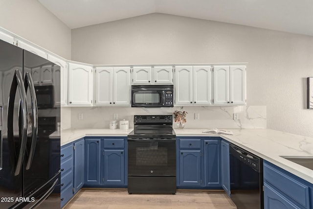 kitchen featuring black appliances, white cabinetry, and blue cabinets