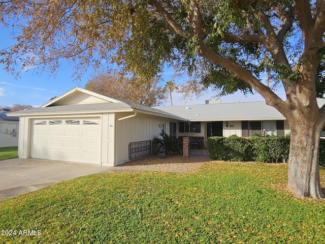 single story home with a front yard and a garage