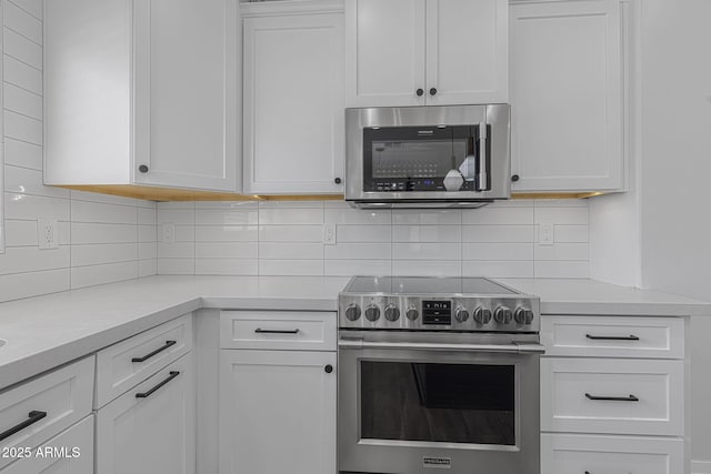 18998 E Lark Dr, Queen Creek, AZ 85142 - kitchen with appliances with stainless steel finishes, white cabinetry, light countertops, and backsplash