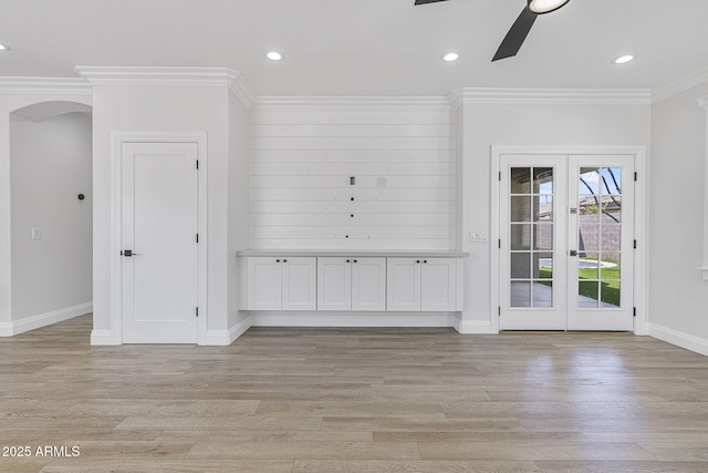 18998 E Lark Dr, Queen Creek, AZ 85142 - empty room featuring a ceiling fan, light wood-type flooring, ornamental molding, arched walkways, and baseboards
