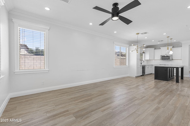 18998 E Lark Dr, Queen Creek, AZ 85142 - unfurnished living room featuring crown molding, recessed lighting, light wood-style floors, ceiling fan, and baseboards