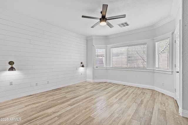 18998 E Lark Dr, Queen Creek, AZ 85142 - empty room featuring a ceiling fan, wood finished floors, crown molding, wooden walls, and baseboards