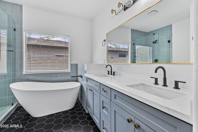 18998 E Lark Dr, Queen Creek, AZ 85142 - full bath featuring a soaking tub, tile walls, tile patterned floors, a stall shower, and double vanity