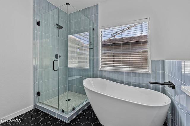 18998 E Lark Dr, Queen Creek, AZ 85142 - full bath with tile patterned flooring, a shower stall, a freestanding tub, and tile walls