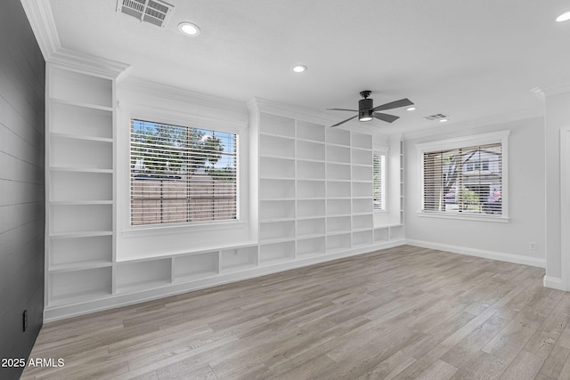 18998 E Lark Dr, Queen Creek, AZ 85142 - empty room featuring ornamental molding, ceiling fan, wood finished floors, plenty of natural light, and built in features