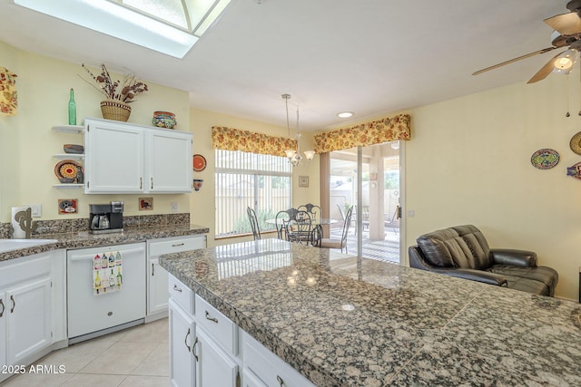 kitchen with open shelves, white cabinets, ceiling fan with notable chandelier, and white dishwasher