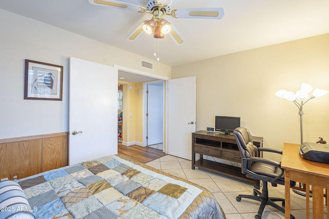 bedroom with tile patterned floors, visible vents, and a ceiling fan