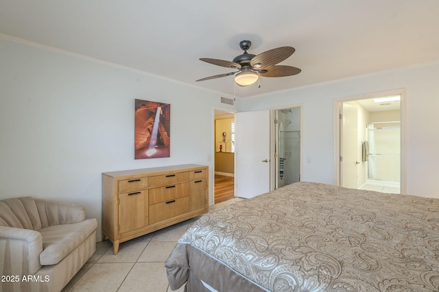 bedroom featuring a ceiling fan, visible vents, light tile patterned flooring, a spacious closet, and crown molding