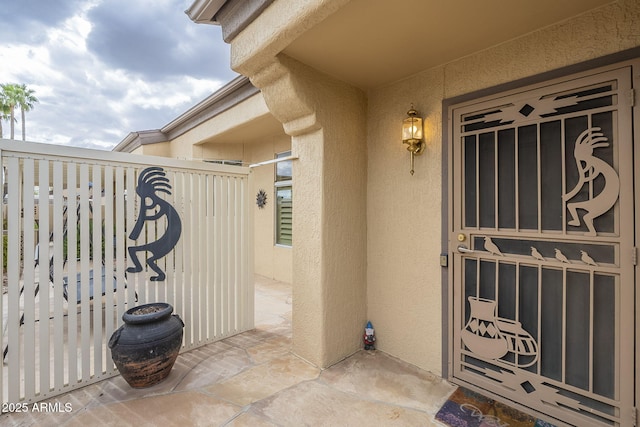 doorway to property featuring stucco siding