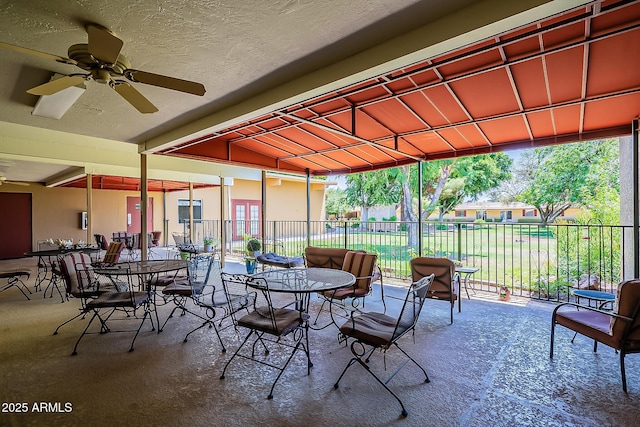 view of patio / terrace featuring outdoor dining area, a ceiling fan, and fence