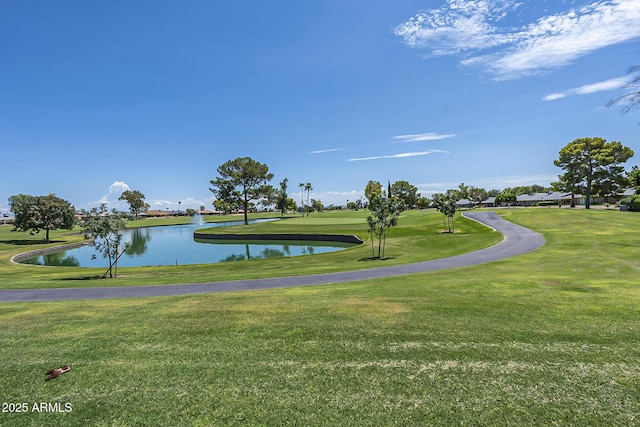 surrounding community with a yard and a water view