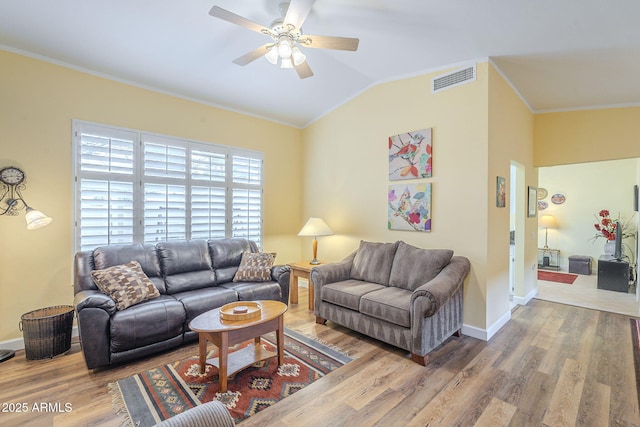 living area featuring wood finished floors, a ceiling fan, visible vents, lofted ceiling, and crown molding