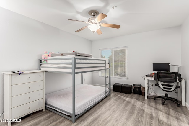 bedroom with ceiling fan and light wood-type flooring