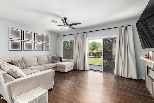 25210 N 40th Ave, Phoenix, AZ 85083 - living room with ceiling fan, dark wood-type flooring, and a glass covered fireplace