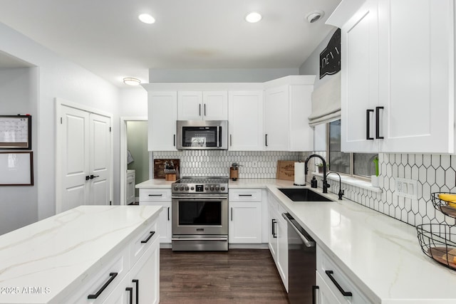 25210 N 40th Ave, Phoenix, AZ 85083 - kitchen with stainless steel appliances, light stone countertops, decorative backsplash, white cabinets, and dark wood-style floors
