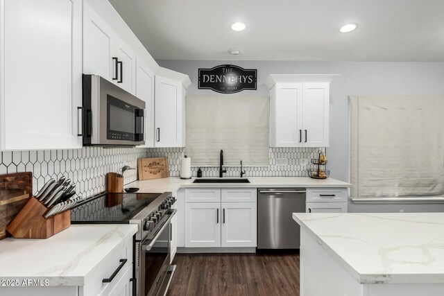 25210 N 40th Ave, Phoenix, AZ 85083 - kitchen with appliances with stainless steel finishes, white cabinetry, tasteful backsplash, dark wood-style floors, and light stone countertops