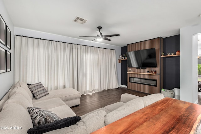 25210 N 40th Ave, Phoenix, AZ 85083 - living area with wood finished floors, a ceiling fan, and a fireplace