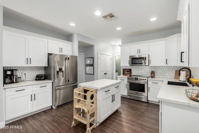 25210 N 40th Ave, Phoenix, AZ 85083 - kitchen featuring appliances with stainless steel finishes, backsplash, dark wood finished floors, white cabinets, and recessed lighting
