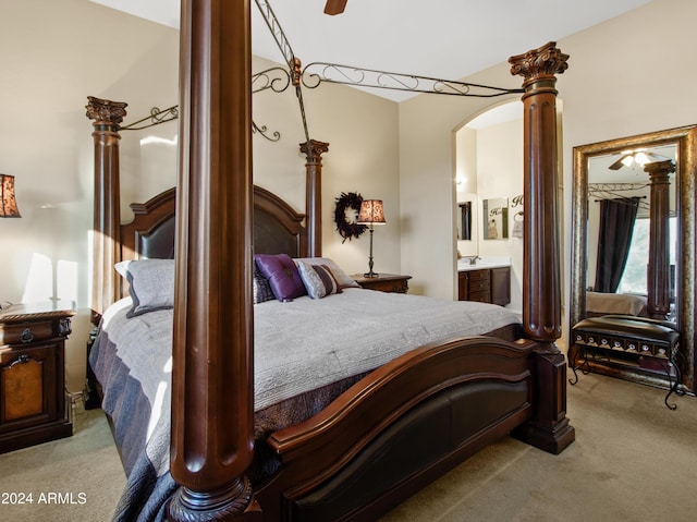 bedroom featuring light colored carpet and ensuite bathroom