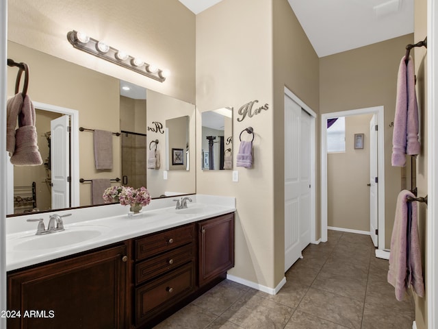 bathroom featuring tile patterned floors, vanity, and an enclosed shower