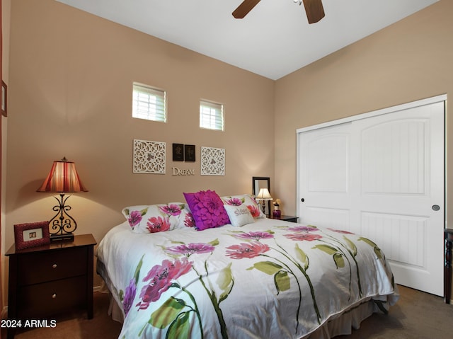 carpeted bedroom featuring a closet and ceiling fan